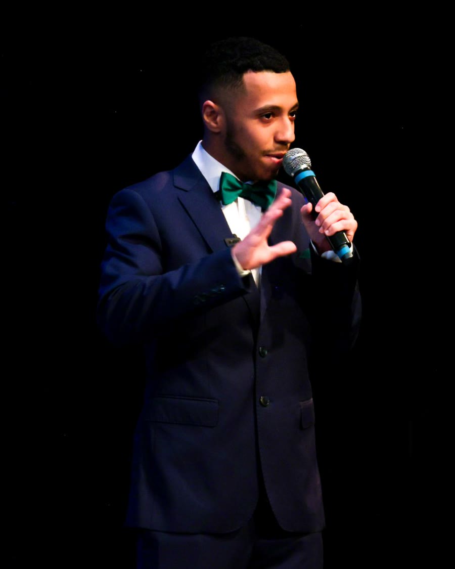 Yazen, founder of Squidaxis, speaking on stage with a microphone